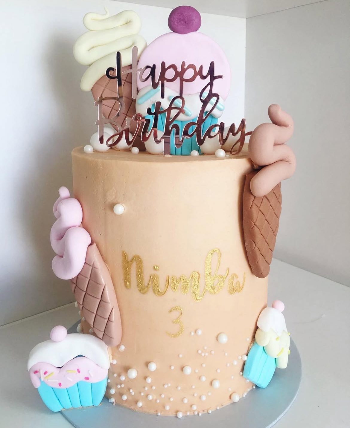 Nude buttercream 3rd birthday cake with cupcake figurine