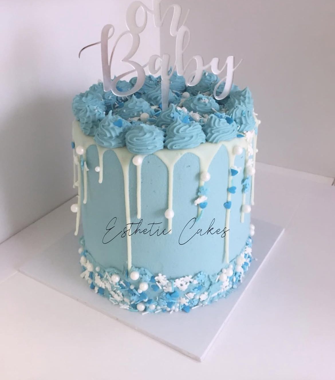 Blue drip birthday cake with strawberries and happy birthday topper