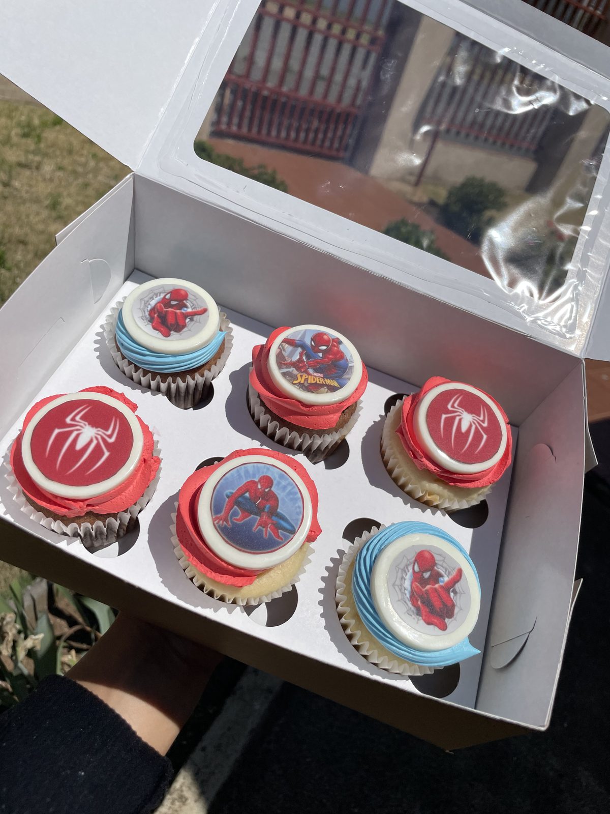 Box of pink and red decorated cupcakes