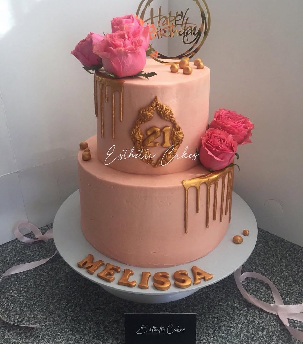 Pink drip birthday cake with gold accents