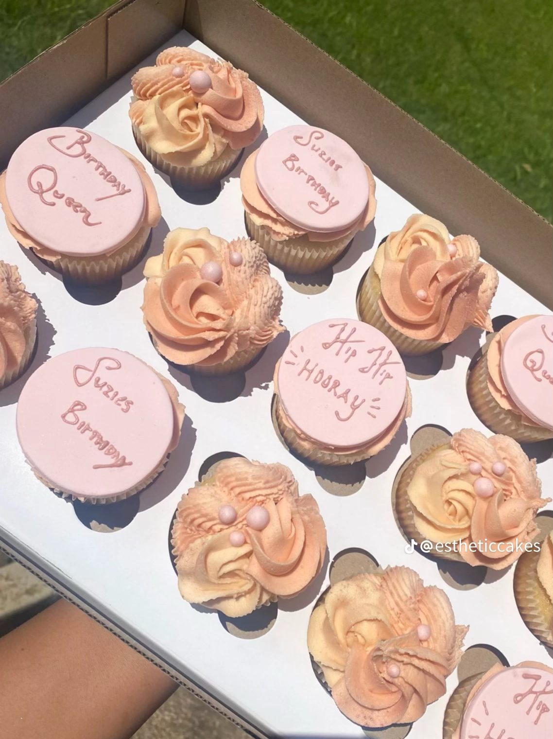 Peach and pink 'Birthday Queen' cupcakes with rose piping