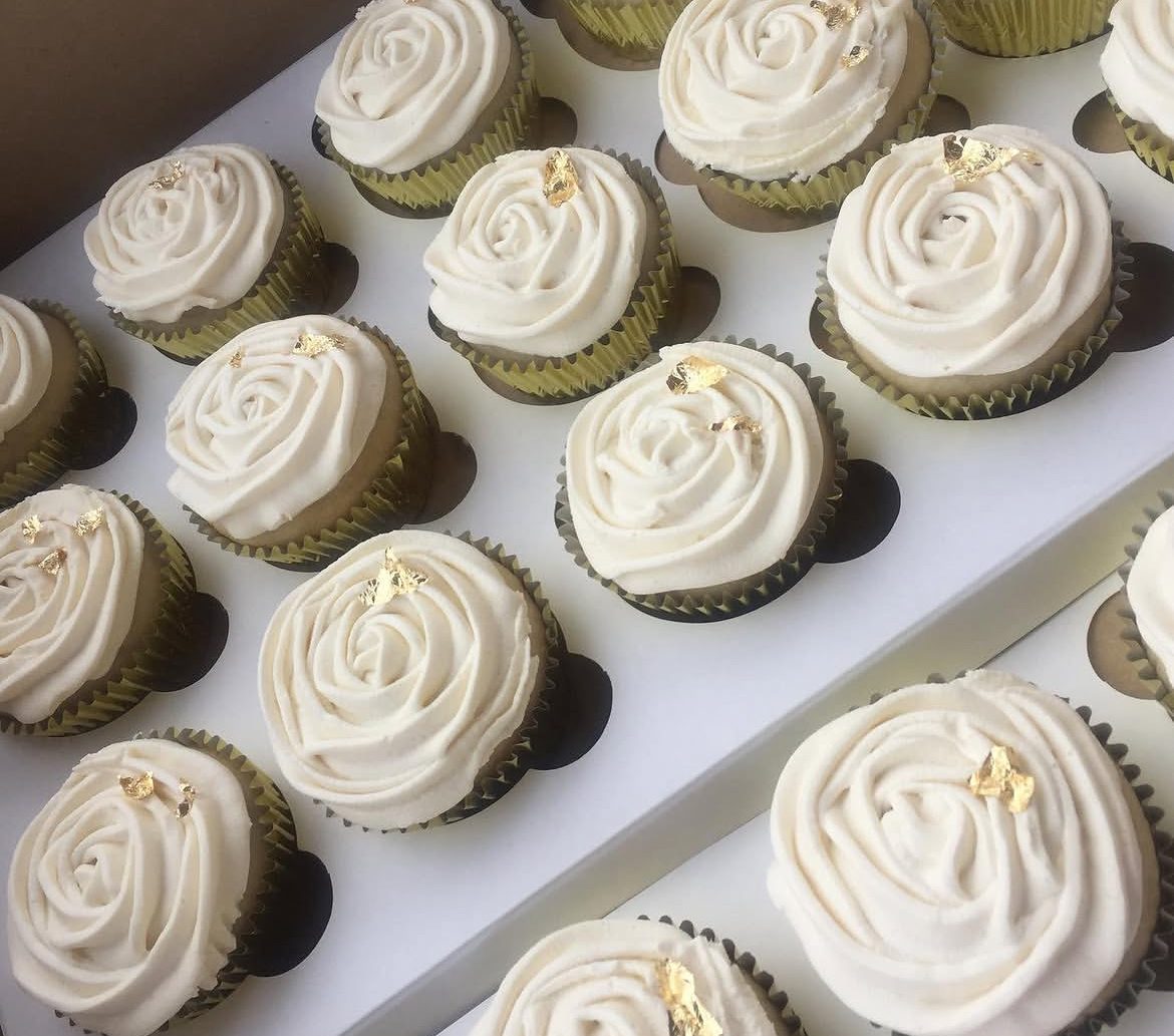 Tray of white buttercream rose cupcakes