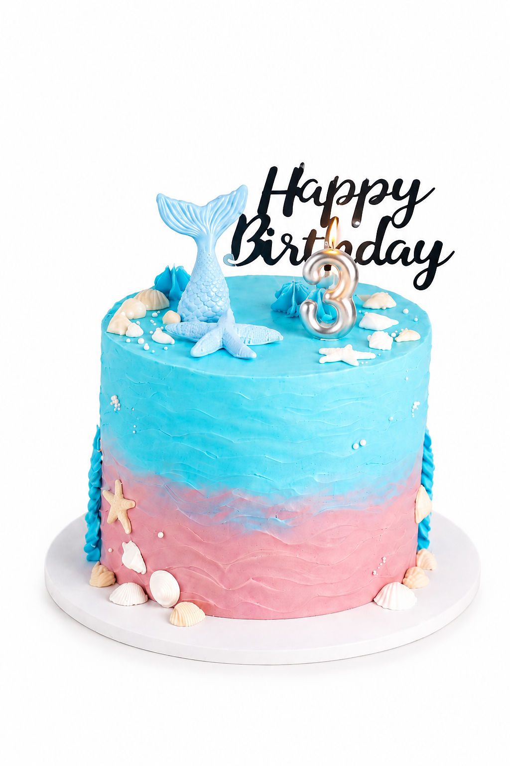 Blue and pink ombré cake with happy birthday topper and whale figurine