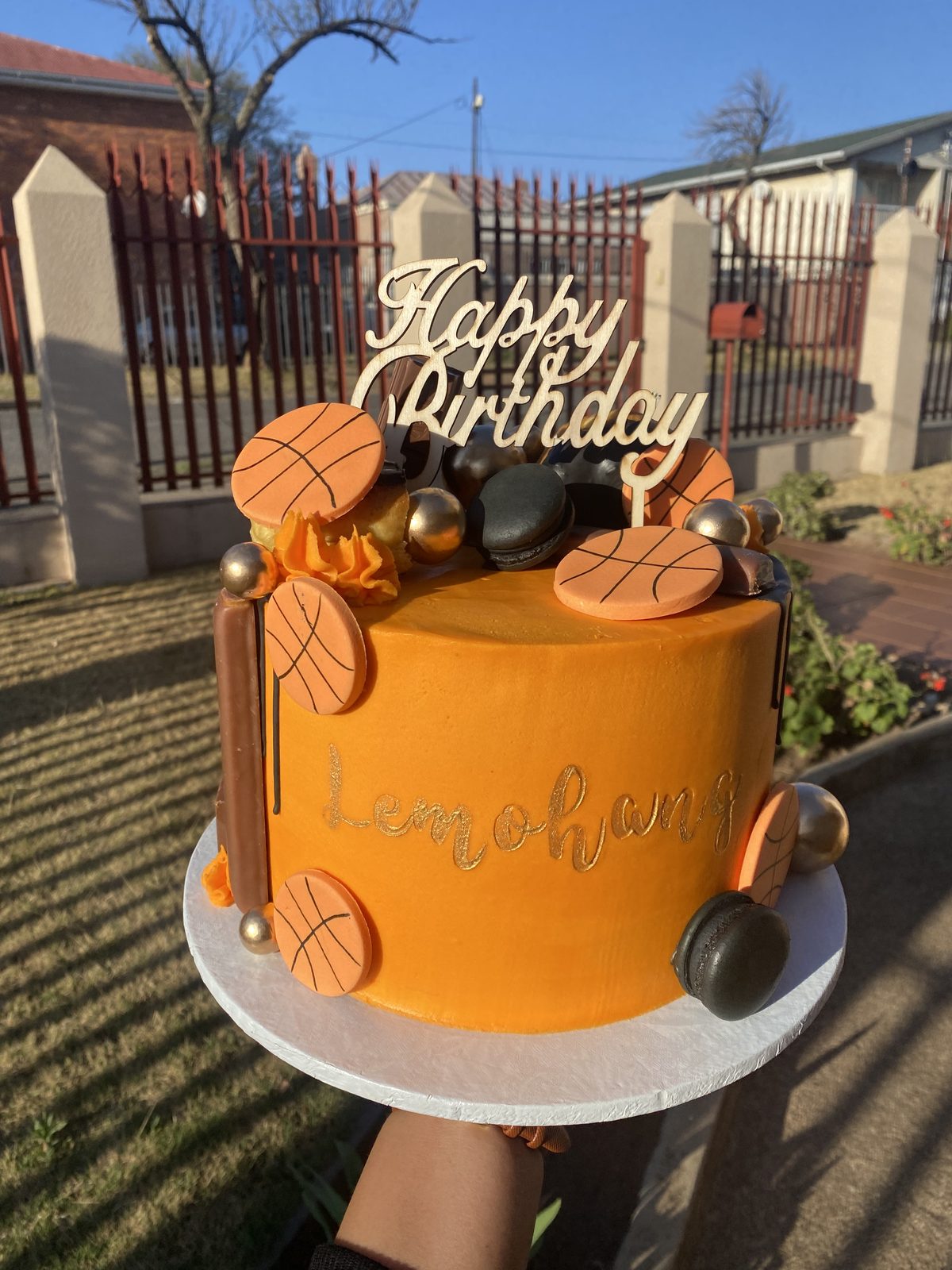 Orange drip birthday cake with gold happy birthday topper