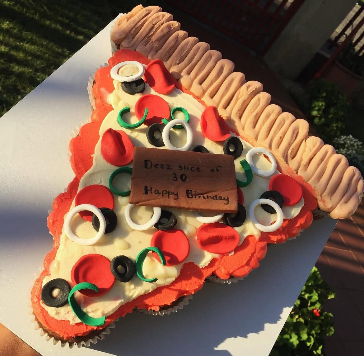 Novelty pizza-shaped celebration cake