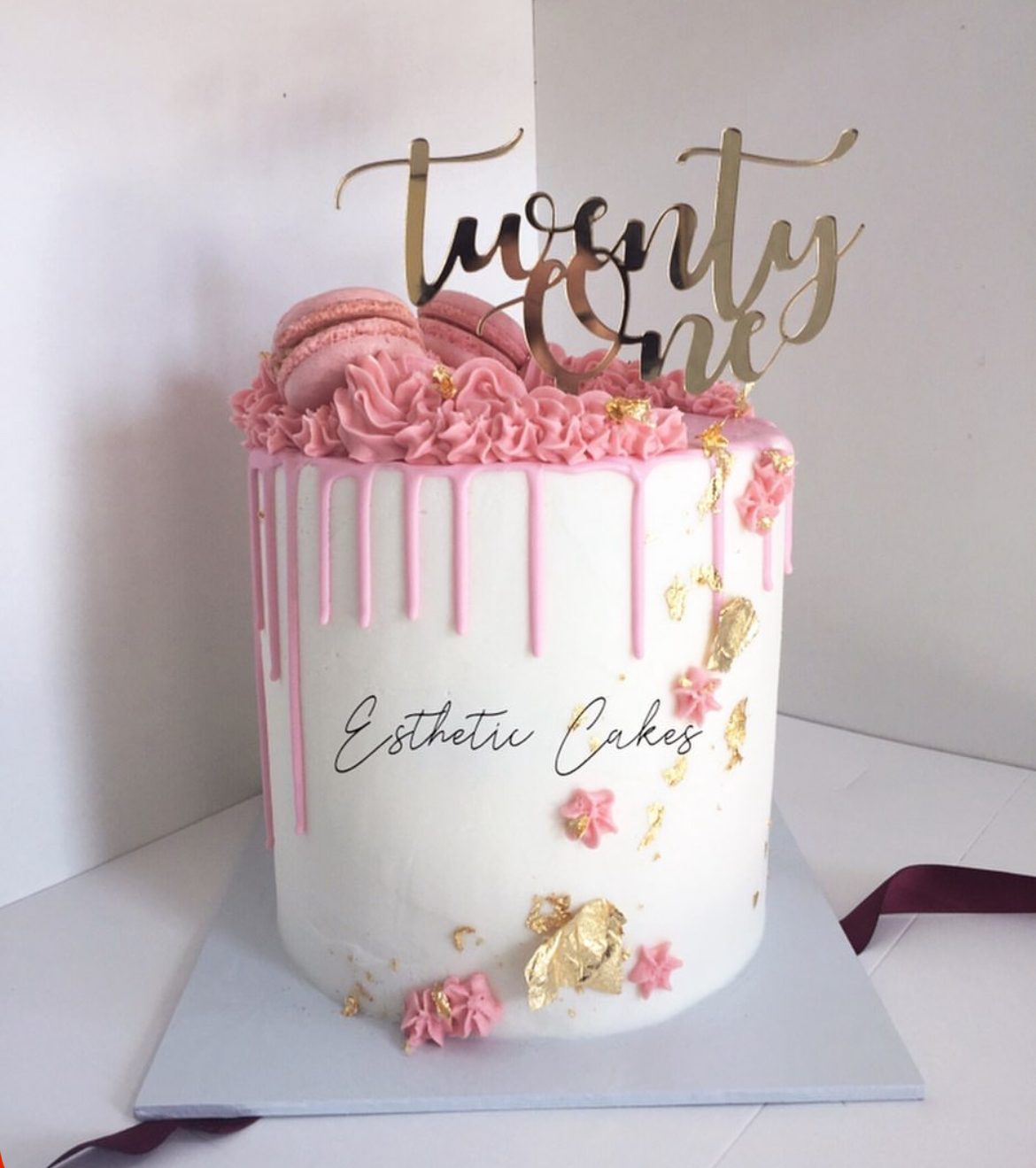 Pink 21st birthday drip cake with 'twenty one' topper
