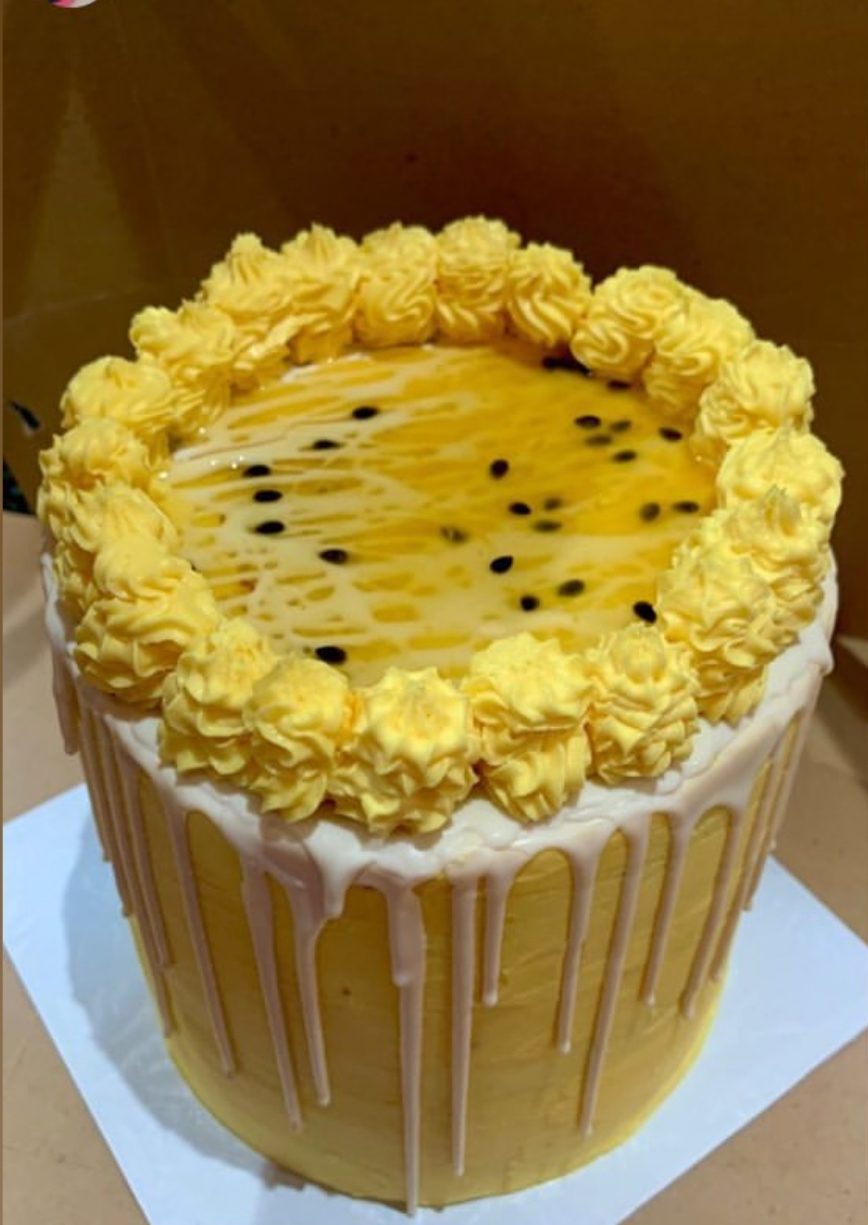 Yellow passion fruit drip cake with buttercream rosette border